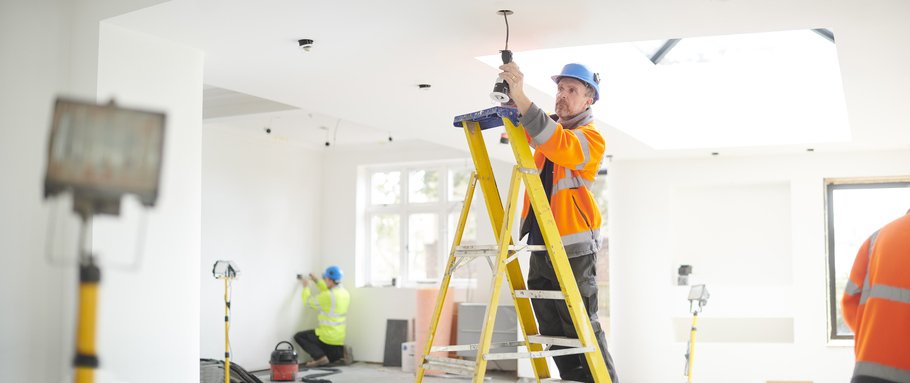 construction worker looking at ceiling light