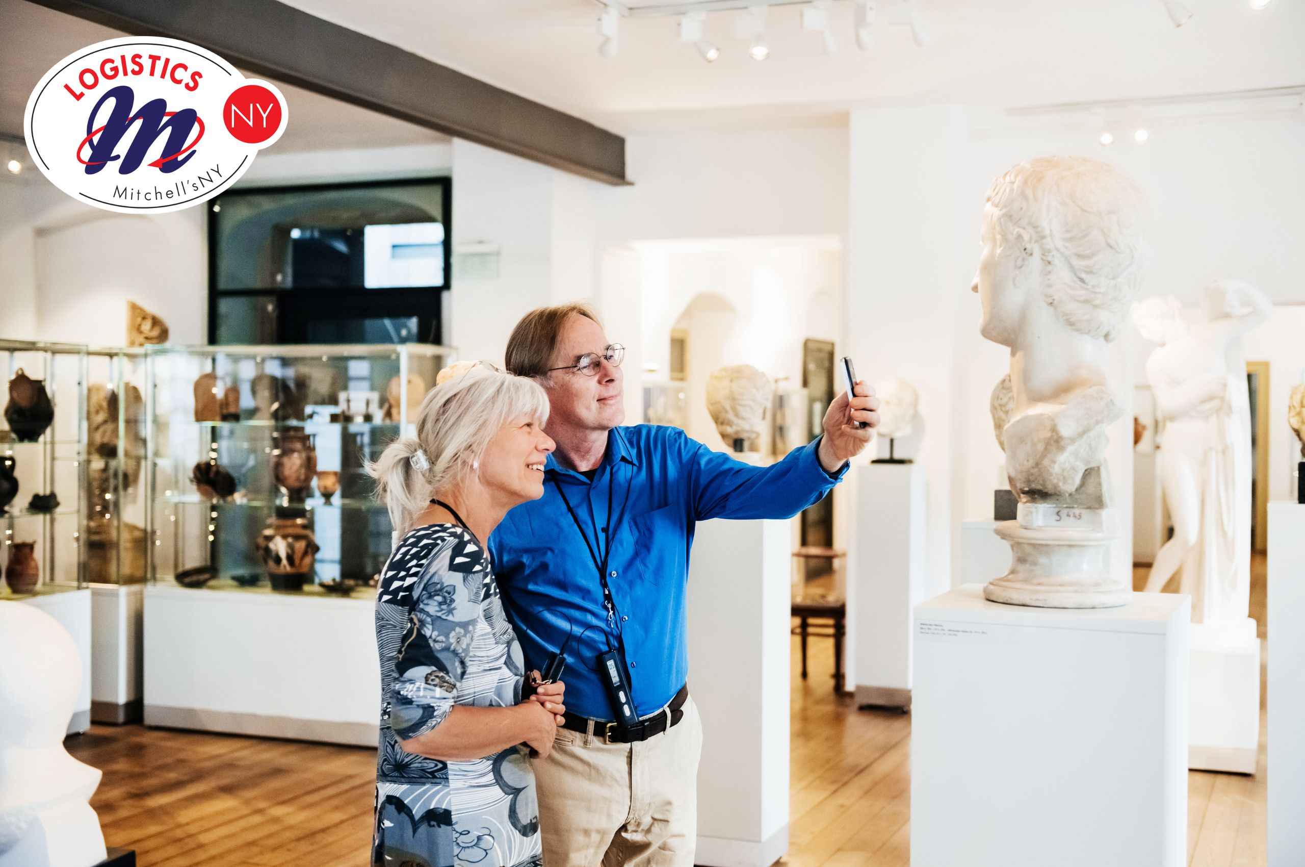 Museum patrons admiring and taking pictures of a sculpture on display in an art exhibit.