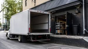 A delivery truck parked into a restaurant loading bay, representing reliable logistics support for hospitality operations in the Northeast.