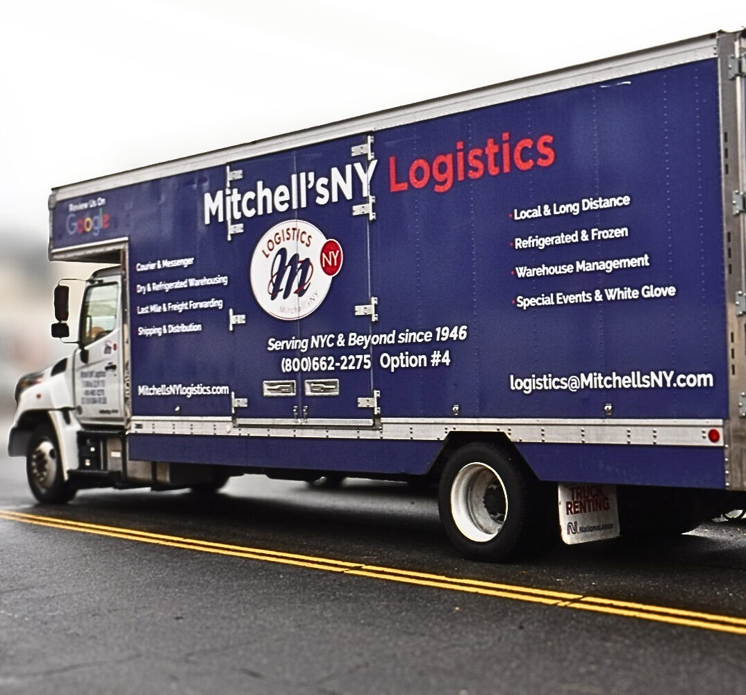 A Mitchell'sNY Logistics truck making a delivery on a New York street.