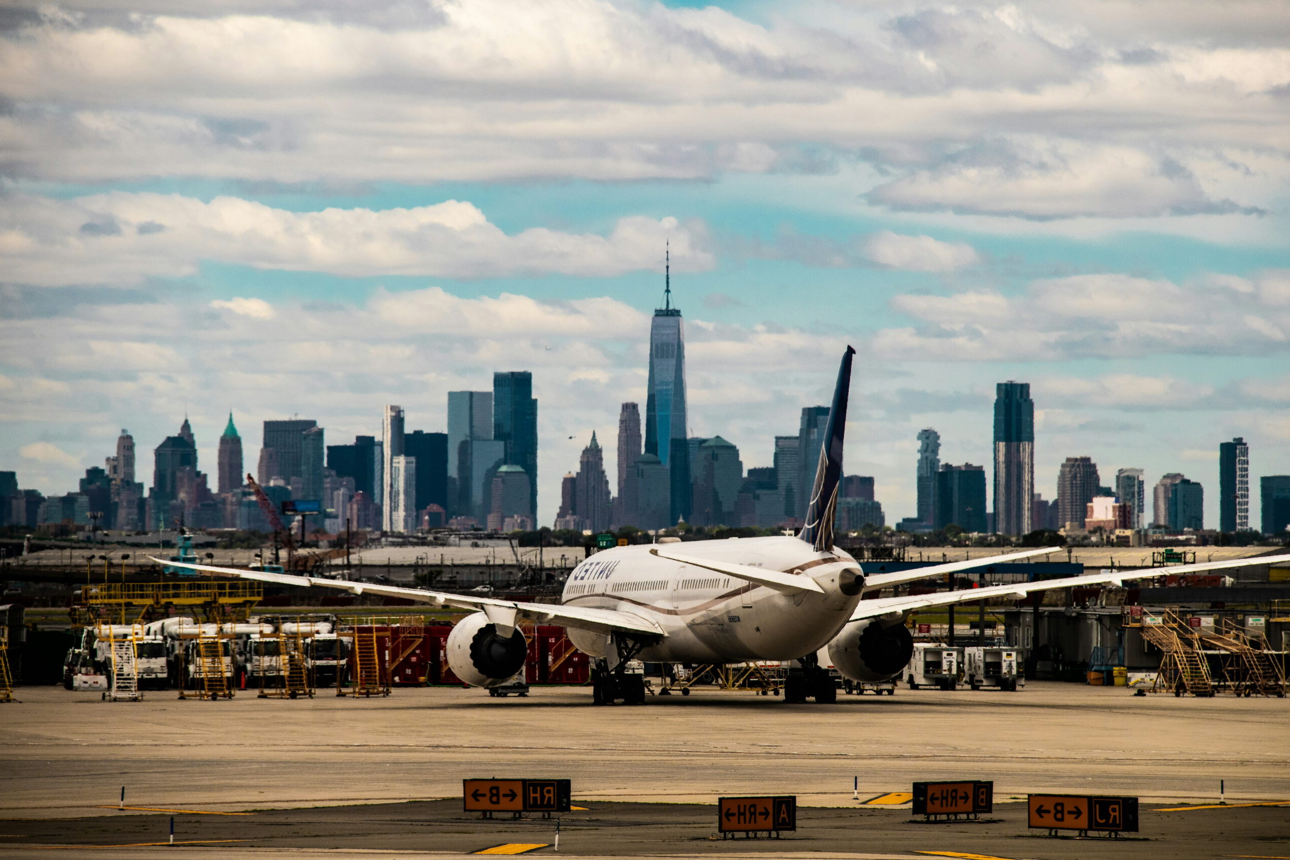 Airplane on the tarmac near Newark Liberty International Airport with the Lower Manhattan skyline in the background, highlighting the regional transportation network that supports Newark-area logistics.