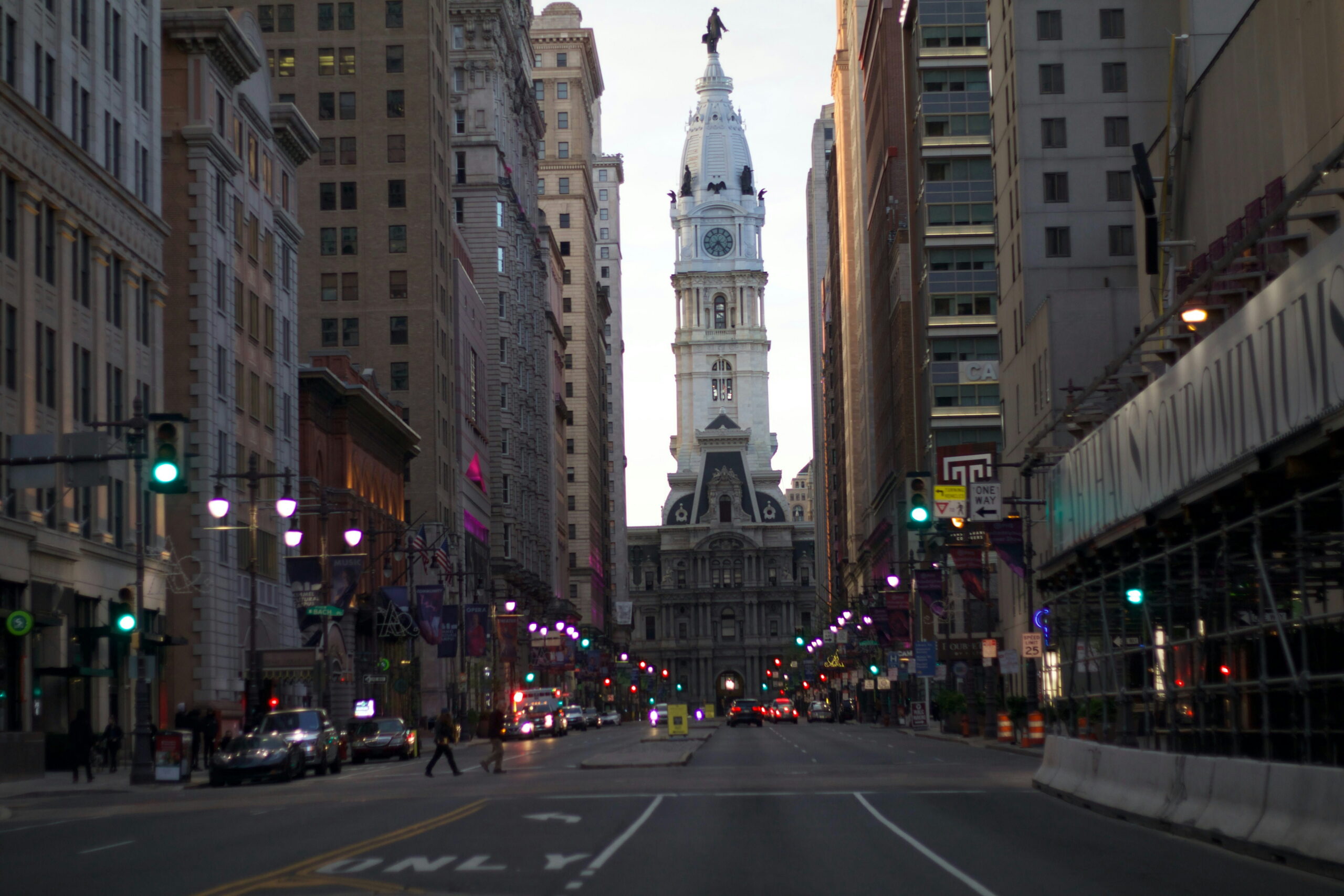 Street level view of Broad Street in Philadelphia with City Hall in the background.
